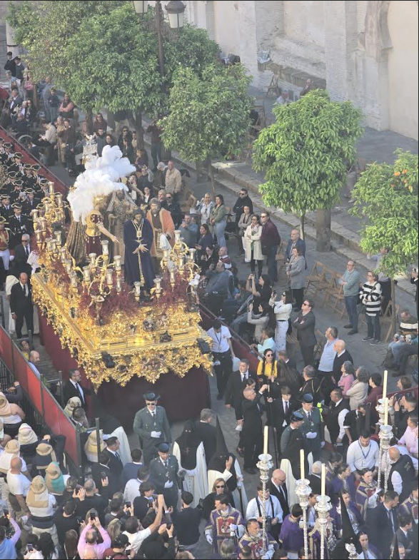 A candlelit paso and its procession